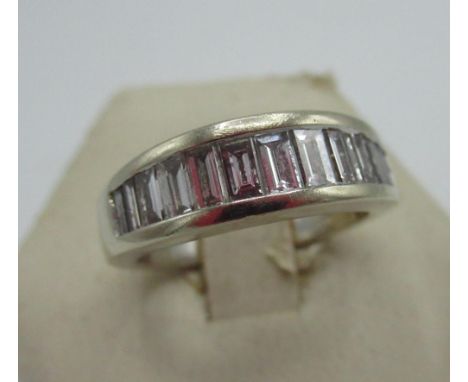 Hallmarked 18ct white gold and diamond ring with fourteen graduated emerald cut, channel set diamonds (marks rubbed), 750, Sh