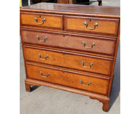 Geo. III mahogany cross banded oak chest of two short above three long moulded drawers, with brass swan necked handles, on sh