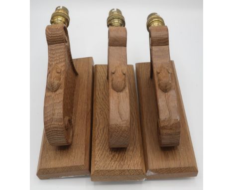 Robert Mouseman Thompson - Set of three adzed oak wall lights with scroll carved detail and signature mouse, on rectangular b