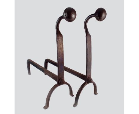 A pair of 17th century style iron andirons each with a ball finial on a swan neck support, on twin out-swept bow legs termina