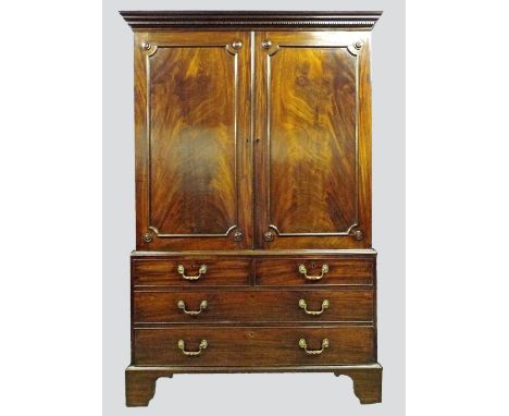 A George III mahogany linen press, the dentil moulded cornice over  two single panel doors, opening to reveal a converted int