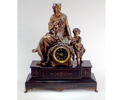 A late 19th century patinated spelter and black slate French mantle clock, the 3 1/2 inch dial signed T. Riol, Nimes within a