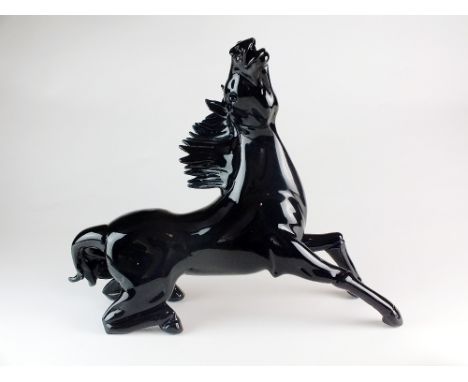 A Murano glass sculpture of a stallion by Pino Signoretto (b.1944-), the black glass horse modelled as if in motion, with eng