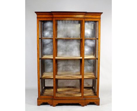 A late 19th century satinwood crossbanded, boxwood and ebony lined strung break-front china display cabinet, the central door