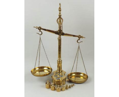 A set of Librasco brass beam scales, the shaped beams with two circular pans hanging from tripod chains, with eight graduatin