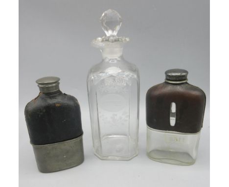Two Edwardian hip flasks with leather covered shoulders, and a 19th century engraved 'Gin' decanter, H22cm (3)