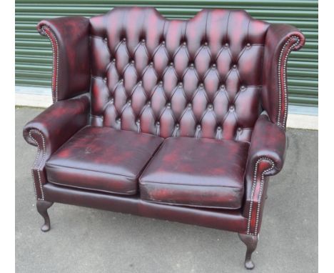 George 111 style oxblood leather two seat high back sofa, on cabriole legs, with loose seat cushions, W134cm D70cm H106cm