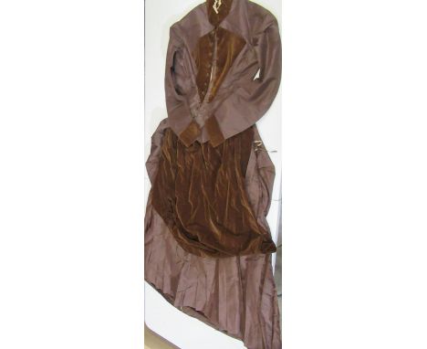 Victorian/Early Edwardian skirt suit featuring a skirt with small integrated bustle and a velvet apron like detail; a blouse 