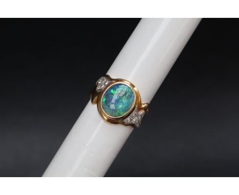 An 18ct gold opal and diamond ring, set with a central fire opal and eleven round brilliant cut diamonds, size S, approximate