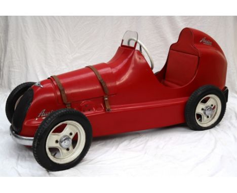 A 1949 Austin Pathfinder pedal car, stamped under the seat 1 36 5 49, pressed steel body work painted red, brown leather stra