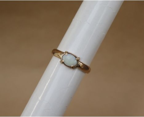 A 9ct yellow gold ring set with an oval opal, size S 1/2, approximately 4 grams