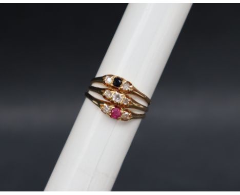 An 18ct gold ruby, sapphire and diamond three-line ring set with old round cut stones to an 18ct yellow gold setting and shan