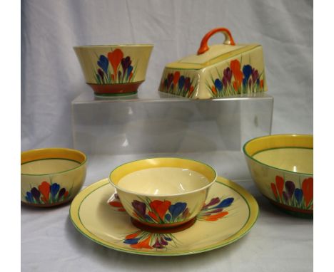 A Clarice Cliff crocus pattern cheese dish together with a similarly decorated plate and four bowls, black printed marks