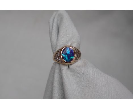 A 9ct yellow gold fire opal and diamond ring, set with a central opal and twenty round old cut diamonds, size O 1/2, approxim