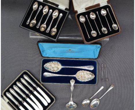 A pair of George III silver berry spoons, the bowls embossed with fruit, London, 1808 and 1837, cased together with a silver 