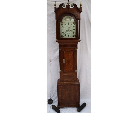 A 19th century oak longcase clock, the hood with a broken swan neck pediment with brass finials, and fluted columns, above a 