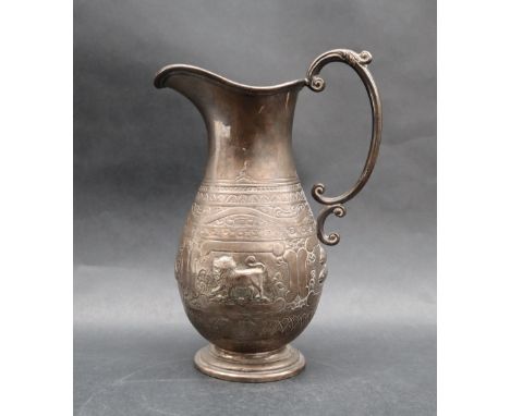 An Indian white metal jug, of baluster form with a C scrolling handle on a spreading foot, embossed with fish, bull, scales a