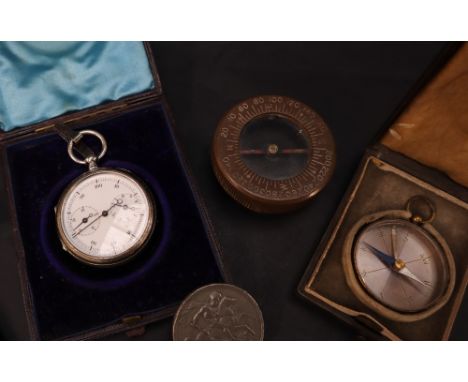 A white metal stop watch, with a white enamel dial and two subsidiary dials, together with a compass in a bakelite case, a US