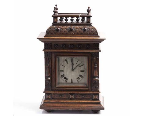 EARLY TWENTIETH CENTURY WINTERHALDER AND HOFMEIER CARVED OAK MANTEL CLOCK
signed two train movement striking on coiled gongs,