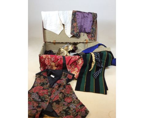 A vintage suitcase with mens waistcoats, scarves, ties and other accessories 