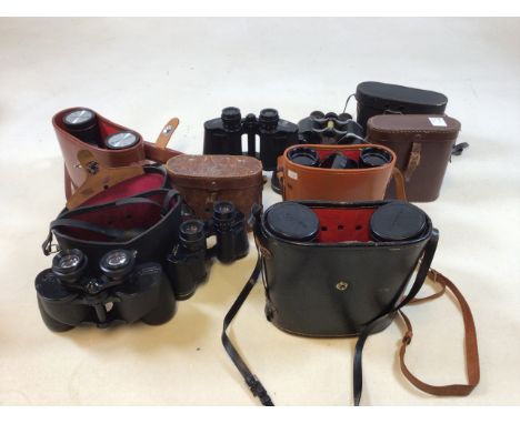 A quantity of binoculars and cases including Pentax and Bell and Howell, Optrilux and others 