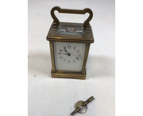 Brass Carriage clock with bevel edge top window, sides and back. Enamel dial - damage to enamel see photo. Complete with orig