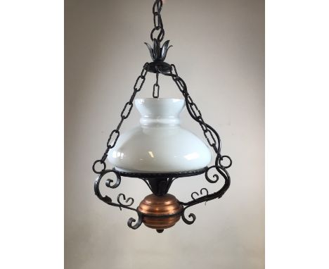 A wrought iron and copper based ceiling light with opaque glass shade 