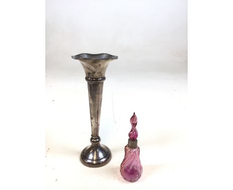 A hallmarked silver vase - weighted to base, with a cranberry glass silver collared scent bottle 