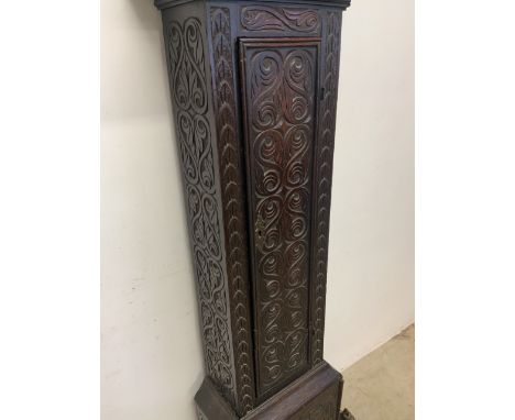 A heavily carved grandfather clock with brass and silvered face marked Sam Harley, Salop. With pendulum and weight. 