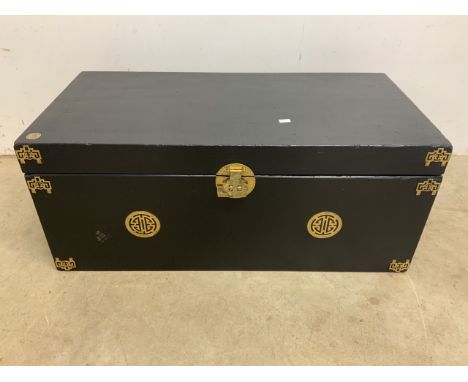 An black painted trunk with brass fittings and rope handles.W:92cm x D:46cm x H:38cm