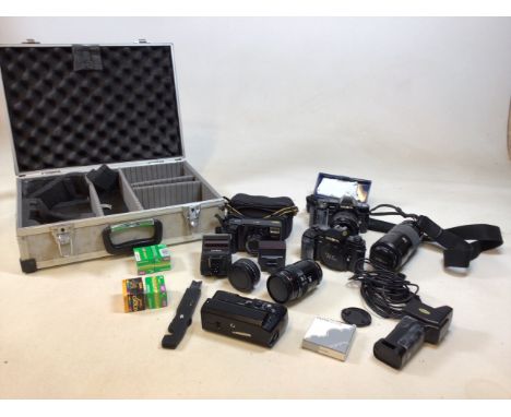 An aluminium case full of Minolta items. Two Minolta SLR cameras models 7000 and 9000. Also with a Minolta AFT compact camera