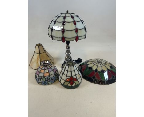 A box of Tiffany style shades and one lamp.