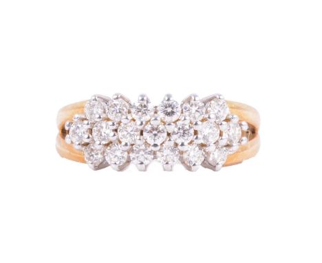 A diamond three row half hoop ring, the nineteen brilliant cut stones claw set in three horizontal rows, in an 18 carat yello