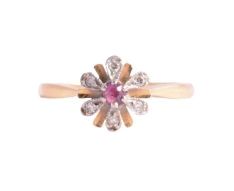 A ruby and diamond floral ring, the old cut ruby claw set and surrounded by six 8 cut diamonds in a floral design, in a yello