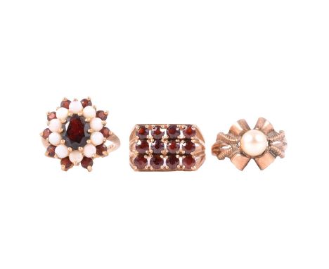 Two garnet dress rings and a cultured pearl ring, a 9 carat yellow gold 18.5mm oval cluster set with a large oval garnet to c