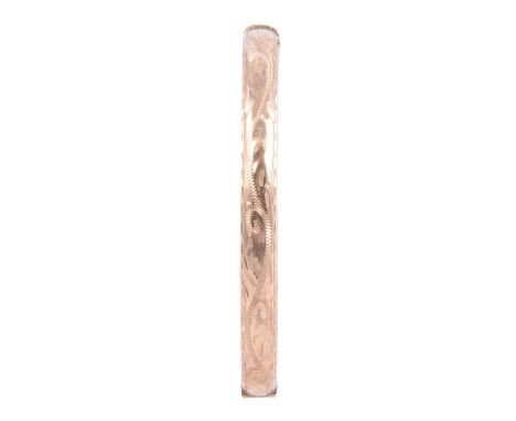 A 9 carat yellow gold half-hinged bangle, 6.3mm wide hollow bangle with bright cut decoration to front, with hook fastener an