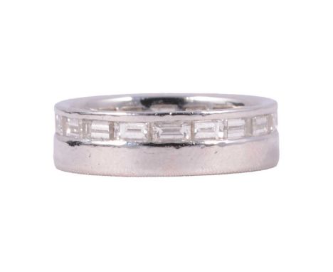 A diamond set wedding/eternity ring, a 5.8mm wide platinum band with eighteen baguette cut diamonds channel set to one side a
