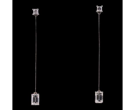 A pair of diamond drop earrings, an emerald cut diamond, 7.1mm x 4.7mm, four claw set and suspended from a 50mm 18 carat whit