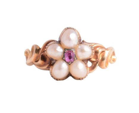 A Victorian ruby and pearl floral design ring, the square cushion cut ruby claw set and surrounded by five pearls in an unmar