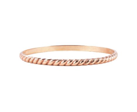 A 9 carat yellow gold solid bangle, 4.3mm D shape fluted twist, internal diameter 62mm, London 1979, 17.6g.