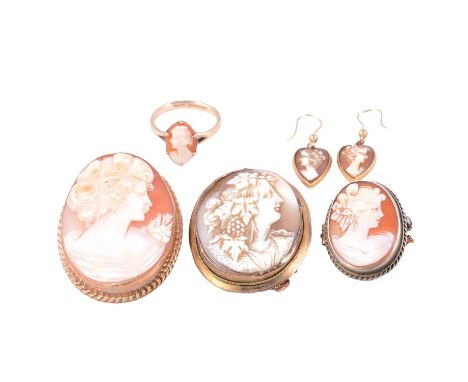 Three cameo brooches, a ring and pair of earrings, a carved shell cameo brooch, female profile facing right, collet set in a 