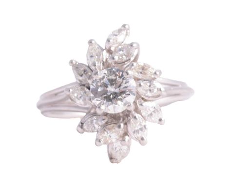 A diamond cluster ring, the central brilliant cut stone, 6mm diameter, surrounded by twelve marquise cut stones in an asymmet