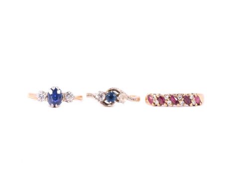 Three gemset rings, ruby and diamond, sapphire and diamond, synthetic sapphire and white zircon, a ruby and diamond half hoop