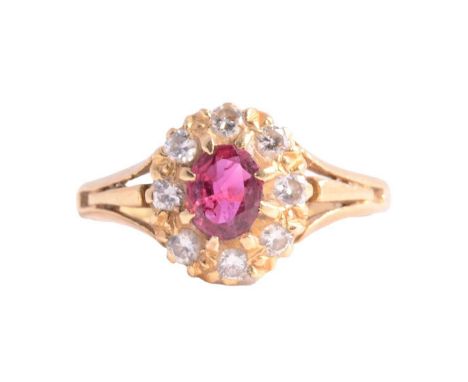A ruby and diamond cluster ring, the oval mixed cut ruby, approximately 5.8x4.6mm, surrounded by eight brilliant cut diamonds