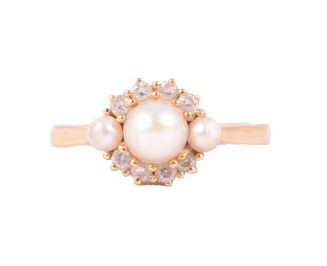 A pearl and diamond ring, the three graduated pearls post set with four brilliant cut diamonds claw set above and below in an
