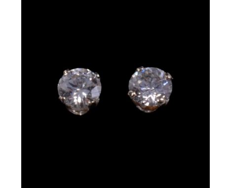 A pair of solitaire diamond stud earrings, the 5.9mm brilliant cut stones four claw set in white metal mounts, pierced fittin