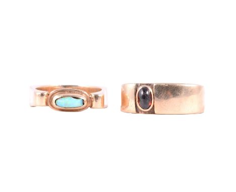Two 9 carat yellow gold dress rings, opal (damaged) and garnet, an opal dress ring, the oval cabochon cut opal (damaged) coll