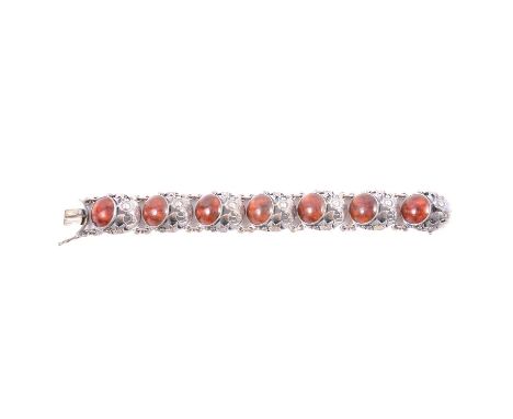 N E From of Denmark - an amber and silver fish panel bracelet, each of the seven panels with a circular cabochon cut amber co