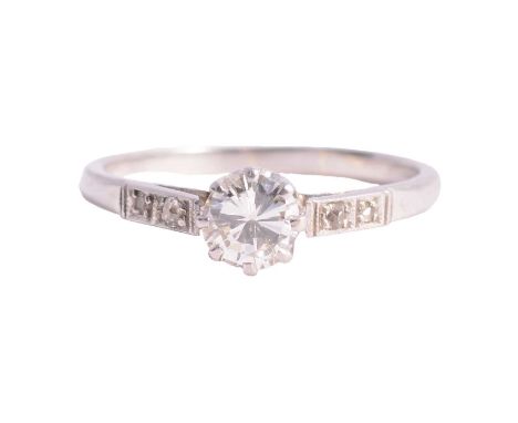 A diamond solitaire ring, the brilliant cut stone claw set in an all white metal mount ring size M, two old cut diamonds set 