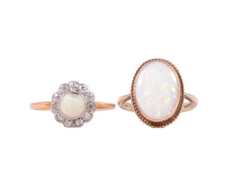 Two opal dress rings. an oval cabochon cut opal, 13x9mm collet set in a 9 carat yellow gold mount, ring size I, 2.7g. a circu